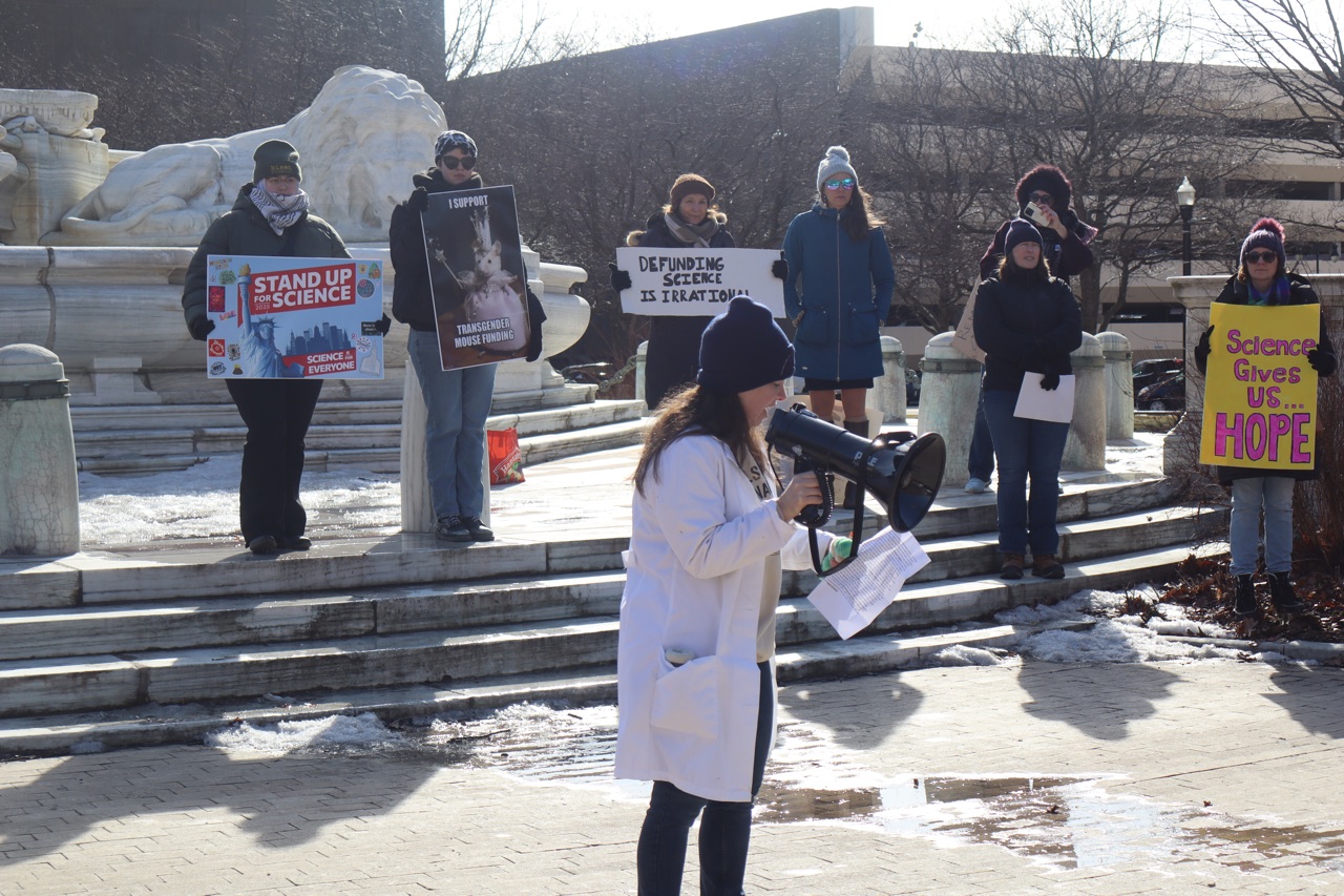 “I Support Transgender Mouse Funding” sign, as held up by a protester