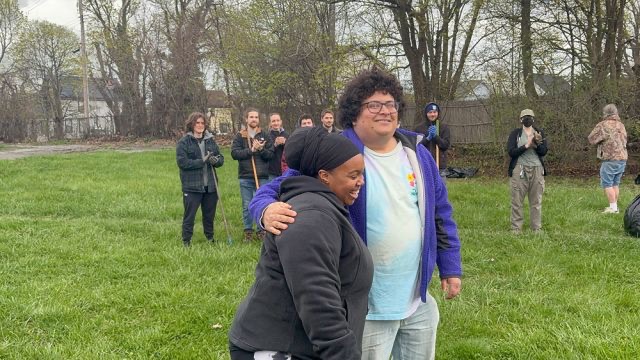 Dr. Tiana U. Wilson and James Coughlin hug after addressing the volunteers at the site.